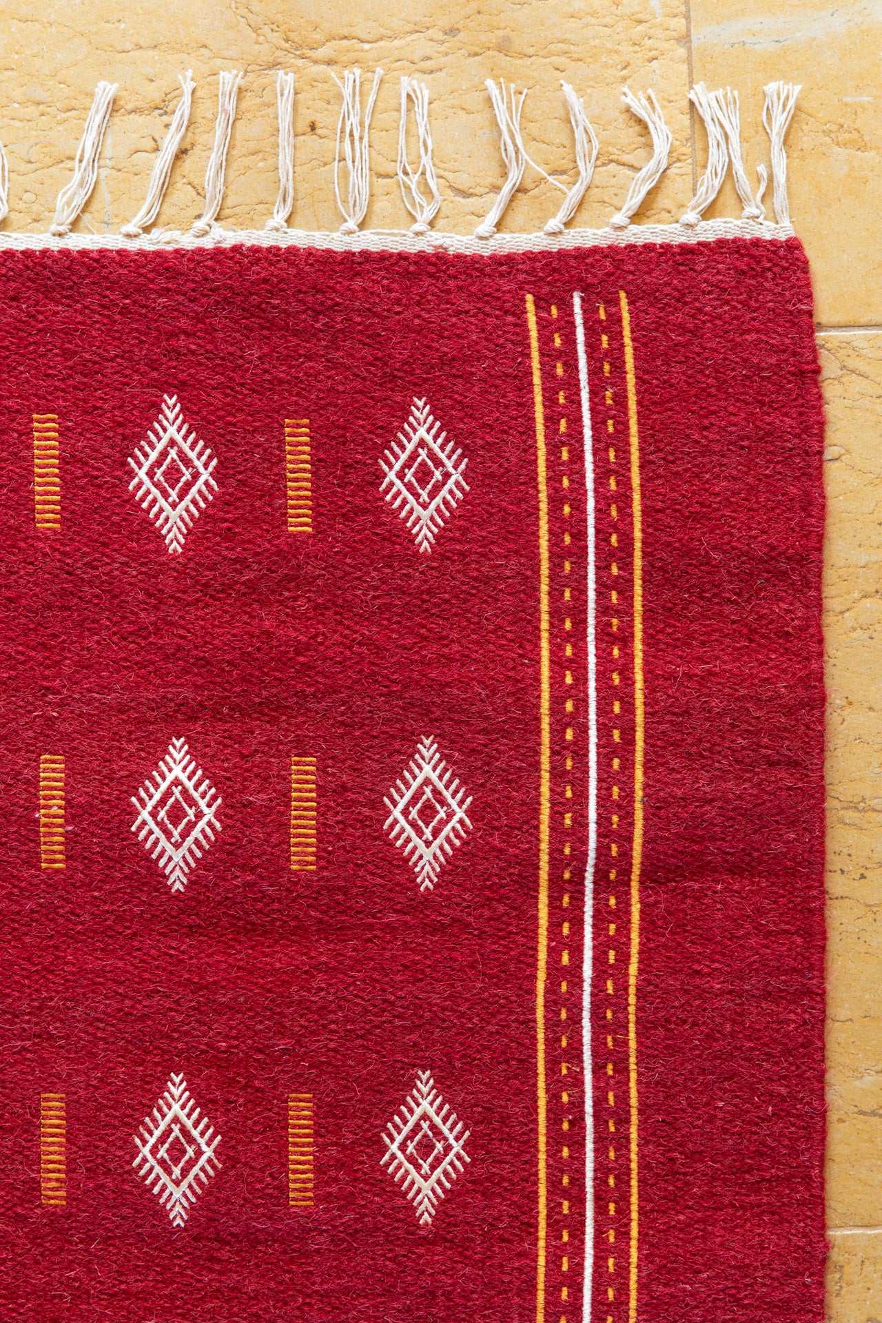 Embroidered red wool carpet